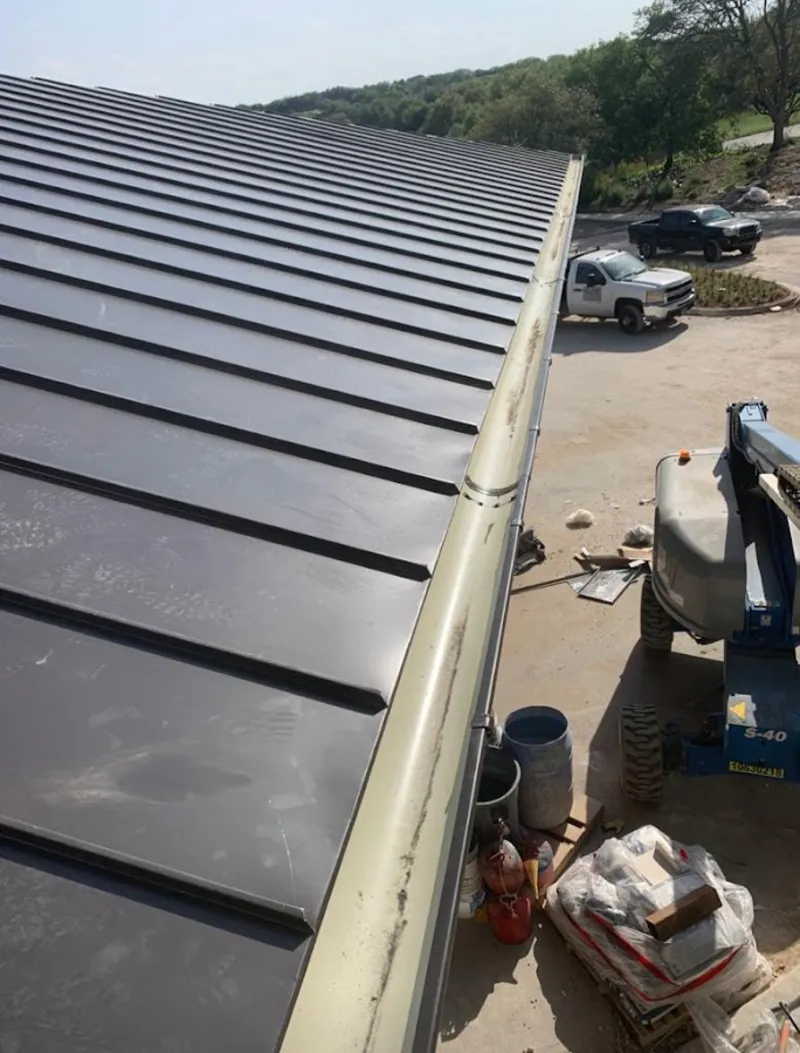 Standing seam panel and gutter detail on a metal roofing jobsite in Oxon Hill